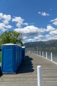 line of porta potties at the lake