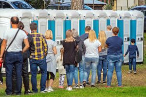 line of people on the porta potties